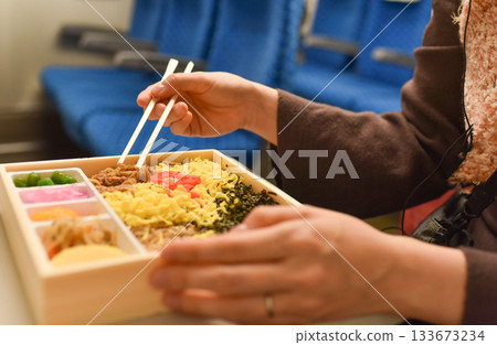 Eating ekiben on the Shinkansen Eating ekiben on the Shinkansen 133673234
