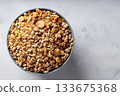 Bowl of Dry Granola Cereal on Gray Background Nutritious Snack Copy Space Bowl of Dry Granola Cereal on Gray Background Nutritious Snack Copy Space 133675368