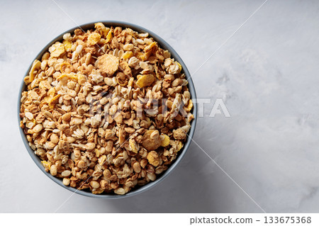 Bowl of Dry Granola Cereal on Gray Background Nutritious Snack Copy Space 133675368