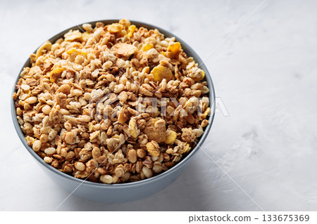 Bowl of Dry Granola Cereal on Gray Background Nutritious Snack Copy Space 133675369