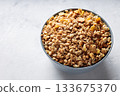 Bowl of Dry Granola Cereal on Gray Background Nutritious Snack Copy Space Bowl of Dry Granola Cereal on Gray Background Nutritious Snack Copy Space 133675370