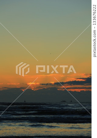 Clouds floating over the sea at sunrise Clouds floating over the sea at sunrise 133676222