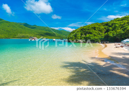 beautiful landscape with white sandy beach in blue lagoon of the sea on tropical paradise island in Asian resort in summer 133676394