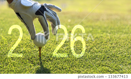 Close up hand Golfer woman putting golf ball for Happy New Year 2026 Close up hand Golfer woman putting golf ball for Happy New Year 2026 133677413