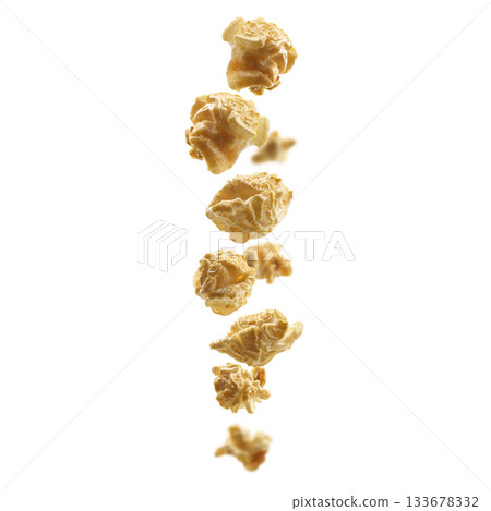 Caramel-flavored popcorn levitates on a white background Caramel-flavored popcorn levitates on a white background 133678332