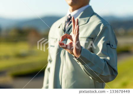A middle-aged male businessman standing outdoors wearing work clothes A middle-aged male businessman standing outdoors wearing work clothes 133678449