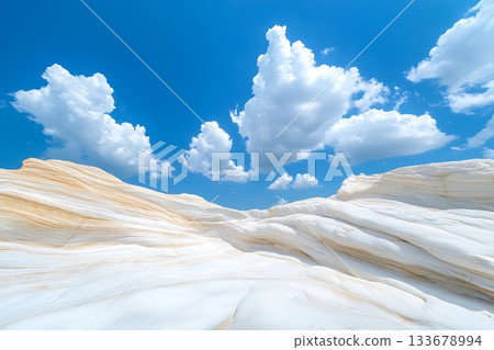 Serene White Rock Formations Under Clear Blue Sky with Fluffy Clouds in Daylight 133678994