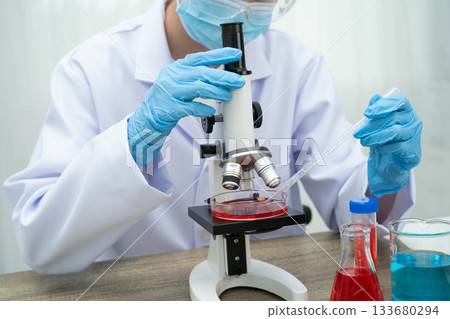 Scientist medical professional use microscope for research in science laboratory. Scientist medical professional use microscope for research in science laboratory. 133680294