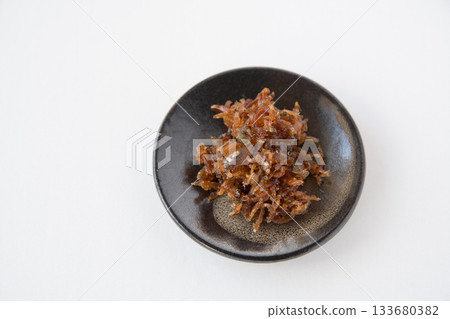 Dried chirimen with Japanese pepper served on a small plate 133680382