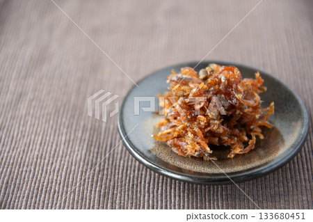 Dried chirimen with Japanese pepper served on a small plate Dried chirimen with Japanese pepper served on a small plate 133680451