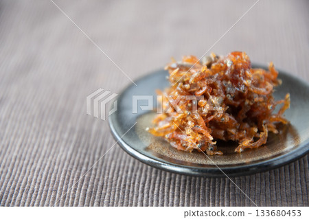 Dried chirimen with Japanese pepper served on a small plate Dried chirimen with Japanese pepper served on a small plate 133680453