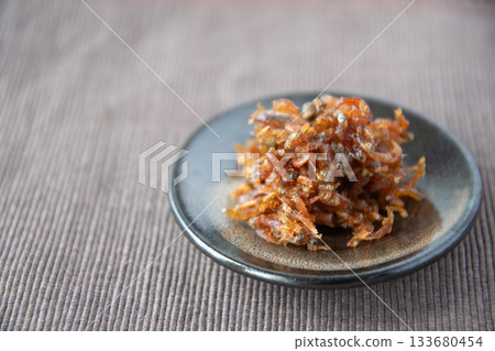 Dried chirimen with Japanese pepper served on a small plate Dried chirimen with Japanese pepper served on a small plate 133680454