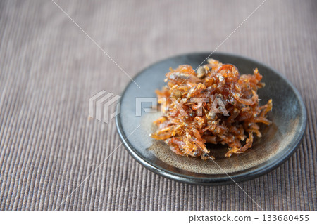 Dried chirimen with Japanese pepper served on a small plate Dried chirimen with Japanese pepper served on a small plate 133680455