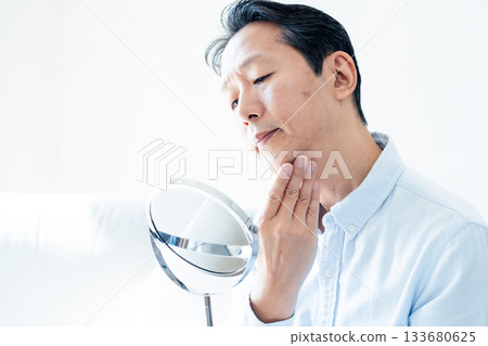 Mature men looking at mirrors 133680625