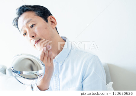 Mature men looking at mirrors 133680626