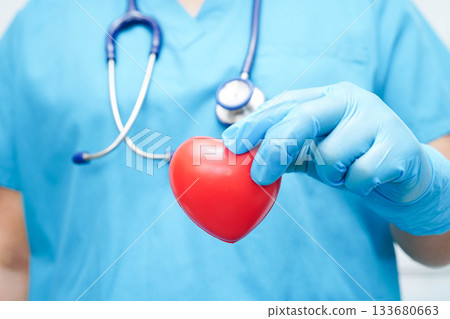 Asian woman doctor holding red heart for health in hospital. 133680663