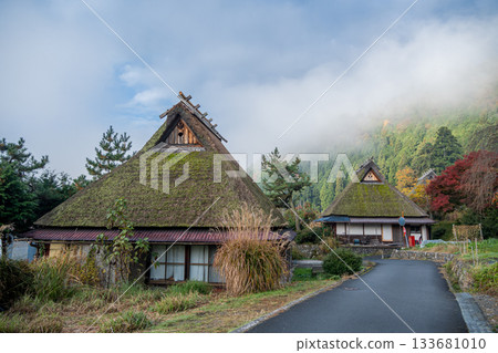 Thatched roof building shrouded in mist 133681010