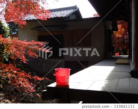 Fire bucket and autumn leaves at Tsugikao Kannon Jakkoin Temple 133681151