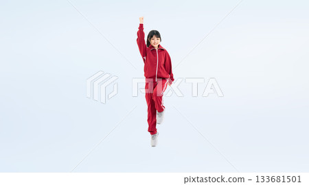 Full-body photo of a female student wearing a gym jersey jumping energetically Full-body photo of a female student wearing a gym jersey jumping energetically 133681501