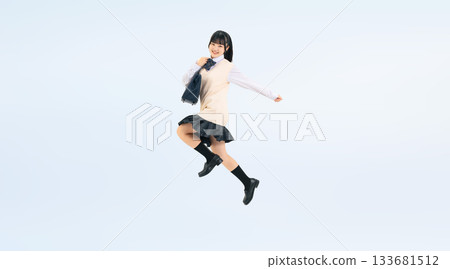 Full-body photo of a female student in a uniform jumping energetically Full-body photo of a female student in a uniform jumping energetically 133681512