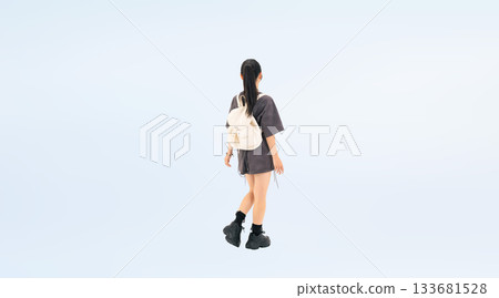 Full-body photo of a walking teenage girl from behind 133681528