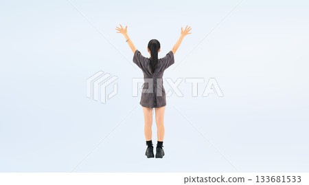 Full-body photo of a teenage girl raising her arms in the air 133681533
