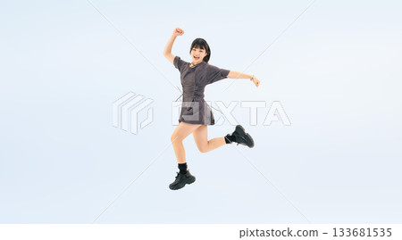 Full-body photo of a teenage girl jumping energetically Full-body photo of a teenage girl jumping energetically 133681535