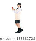 Female student in uniform using a smartphone. Full-body photo PNG with transparent background, precisely cut out by hand. 133681728