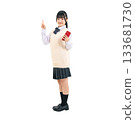 A female student in uniform holding a smartphone and giving directions. A transparent, hand-cut, full-body PNG photo. 133681730