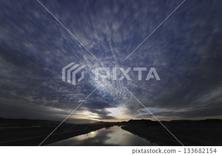 A refreshing dawn sky with various clouds and a river. Spring. Ultra-wide angle. Sky-focused. 240328am A refreshing dawn sky with various clouds and a river. Spring. Ultra-wide angle. Sky-focused. 240328am 133682154