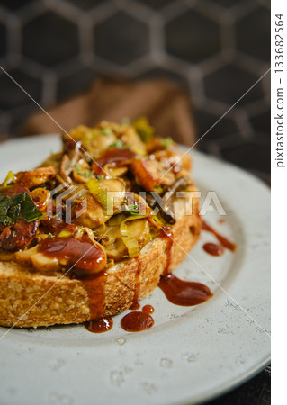 Delicious mushroom sandwich with honey, enoki, and champignon on fresh bread 133682564