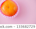 Shiny and richly sweet, the Fuyu persimmon has a vibrant warm orange color. 133682729