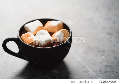 cup of hot chocolate with marshmallow on terrazzo background 133682906