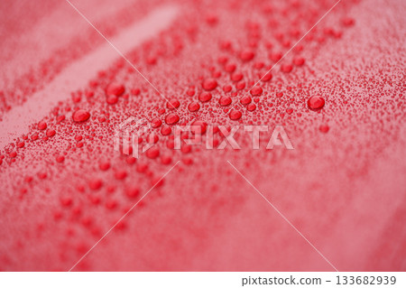 raindrops on ceramic coated red car with hydrophobic effect 133682939