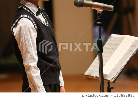 Boy singing on stage 133682985