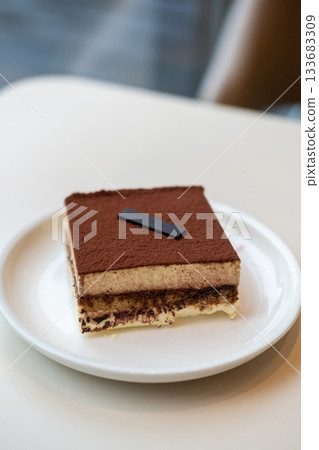 Square Tiramisu served on plate in the cafe Square Tiramisu served on plate in the cafe 133683309