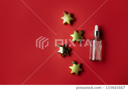 Serum on red background with golden star shaped decorations 133683887