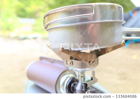 A shot of the browning of the bottom of a titanium pot and the gear of an outdoor burner A shot of the browning of the bottom of a titanium pot and the gear of an outdoor burner 133684086