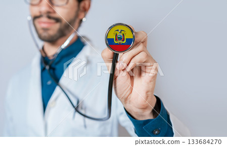 Doctor holding stethoscope with Ecuador flag. Ecuador health and care concept. Ecuador flag on stethoscope 133684270