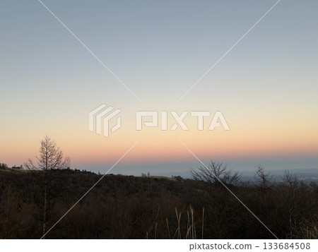 A tranquil mountain landscape dyed in the gradation of the sunset A tranquil mountain landscape dyed in the gradation of the sunset 133684508