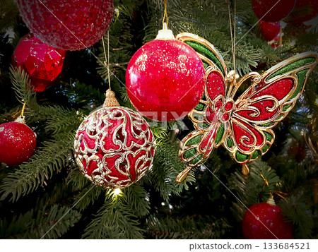 Christmas ornaments on the Christmas tree. Toys and red balls. 133684521
