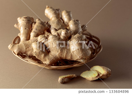 Ginger root on a beige background. Ginger root on a beige background. 133684896
