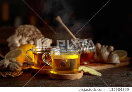 Cup of ginger tea with lemon, honey, and ginger root. Cup of ginger tea with lemon, honey, and ginger root. 133684899