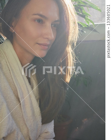Woman in Robe Bathed in Golden Sunlight, Morning Serenity 133685021
