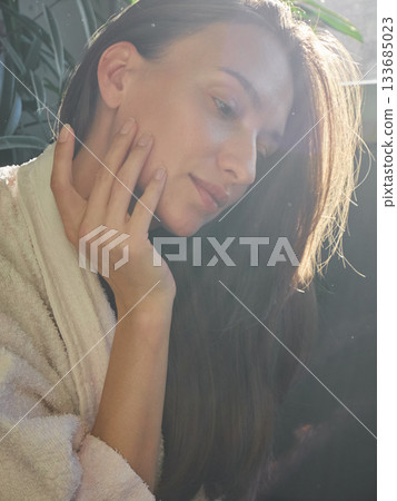 Woman in Robe Bathed in Golden Sunlight, Morning Serenity 133685023