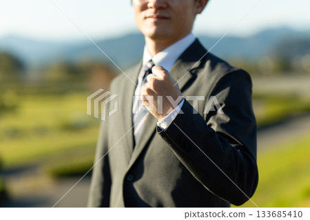 A middle-aged male businessman wearing a suit standing outdoors A middle-aged male businessman wearing a suit standing outdoors 133685410