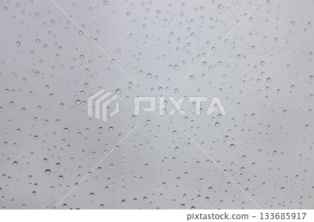 Raindrops on Window Glass with Grey Sky, Water Droplet Texture Background 133685917