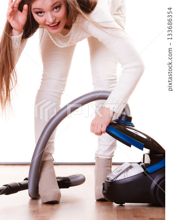 Funny girl with vacuum cleaner. Housework 133686354