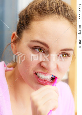 Woman brushing cleaning teeth in bathroom 133686375