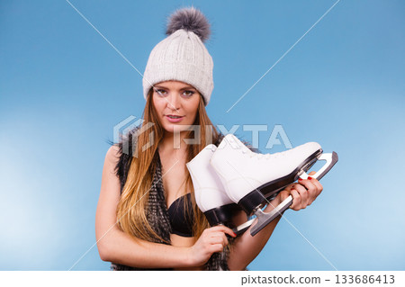 Attractive lady with ice skates. Attractive lady with ice skates. 133686413